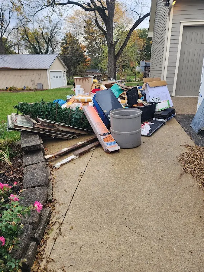 Dumpster being loaded with debris for 30 Yard Dumpster Rental in Liberty